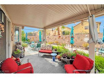 Cozy covered patio with comfortable seating and colorful garden decor, perfect for outdoor relaxation and entertaining at 9412 Jewel Lake Ave, Las Vegas, NV 89166