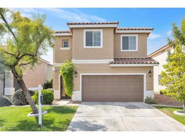 Charming two-story home features a well-manicured lawn and two-car garage in a desirable neighborhood at 9465 Perennial View Ave, Las Vegas, NV 89148