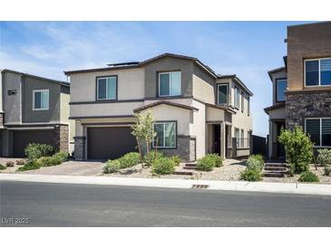 Contemporary two-story home with neutral stucco, stylish landscaping, and an attached two-car garage at 9732 Abel Cliff St, Las Vegas, NV 89143