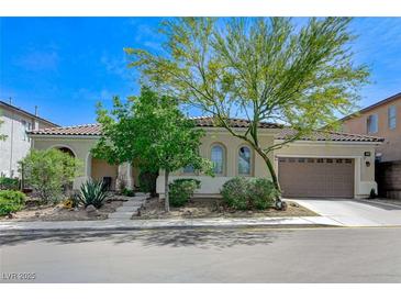 Charming single-story home with a well-manicured front yard and two-car garage under a brilliant, sunny sky at , Las Vegas, NV 89149