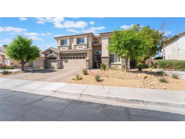 A two-story home featuring a three-car garage and well-maintained landscaping at 1291 Rolling Sunset St, Henderson, NV 89052