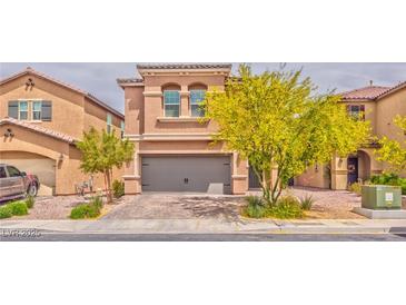 Charming two-story home with a gray two-car garage and well-maintained landscaping at 156 Fulgora St, Henderson, NV 89074