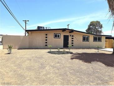 Charming single-story home featuring a neutral color palette, complemented by a meticulously landscaped front yard at 1836 Mcdaniel St, North Las Vegas, NV 89030