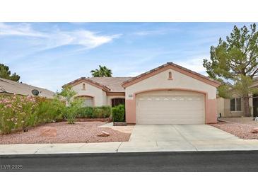 Charming single-story home featuring a two-car garage and desert landscaping at 2103 Poppywood Ave, Henderson, NV 89012