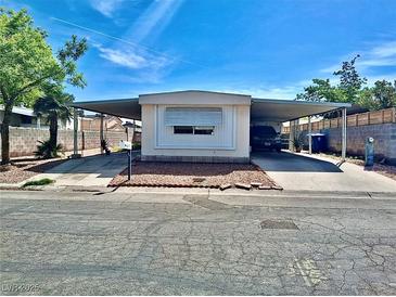 Cozy home featuring a convenient two-car carport and well-maintained landscaping, creating an inviting curb appeal at 3747 Pecan Ln, Las Vegas, NV 89115