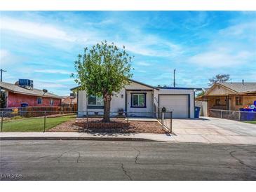 Charming single-story home with a well-maintained yard and a driveway leading to an attached garage at 4432 Ash Ave, Las Vegas, NV 89110