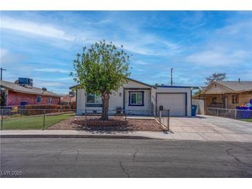 Charming single-story home with a well-kept front yard, fenced lawn, and a mature tree at 4432 Ash Ave, Las Vegas, NV 89110