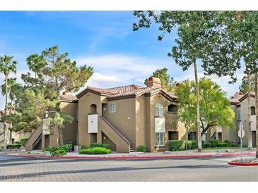 Charming apartment complex featuring stucco facade, red tile roof, and lush landscaping at 9000 Las Vegas Blvd # 1004, Las Vegas, NV 89123
