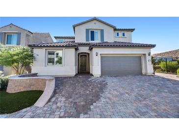 Charming two-story home featuring a beautiful paver driveway and attached two-car garage at 12705 Coastline Shadow St, Las Vegas, NV 89141