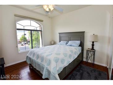 Bedroom featuring a ceiling fan, large window, and light color scheme at 1605 Crimson Hills Dr # 204, Las Vegas, NV 89128