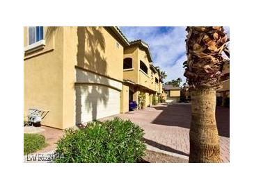 Beautiful townhome features a private garage and lush landscaping at 1605 Crimson Hills Dr # 204, Las Vegas, NV 89128