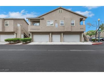 Inviting townhouse complex with attached garages and well-maintained landscaping at 2052 Gravel Hill St # 207, Las Vegas, NV 89117