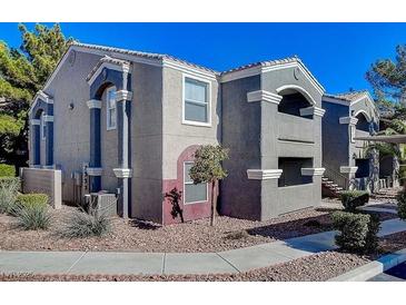 Beautiful apartment building featuring a gray stucco exterior and a terra cotta tile roof at 5055 W Hacienda Ave # 1161, Las Vegas, NV 89118