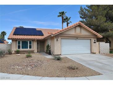 Charming single-story home with a two-car garage, desert landscaping, and a terracotta roof at 5638 Morning Song Cir, North Las Vegas, NV 89031