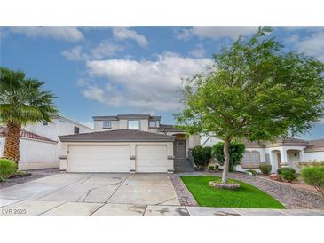 Charming home with a two-car garage, lush landscaping, and brick-lined driveway, creating curb appeal at 760 Camino La Paz, Henderson, NV 89012