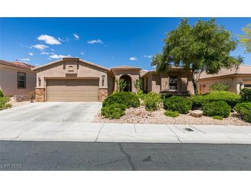 Charming single-story home featuring a two-car garage and desert landscaping at 10372 Premia Pl, Las Vegas, NV 89135