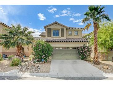 Charming two-story home featuring desert landscaping, a two-car garage, and mature palm trees at 10519 Bella Camrosa Dr, Las Vegas, NV 89141
