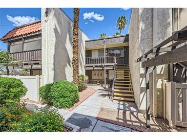 Inviting condo exterior with well-maintained landscaping and stairway access to the second level at 1420 Vegas Valley Dr # 22, Las Vegas, NV 89169