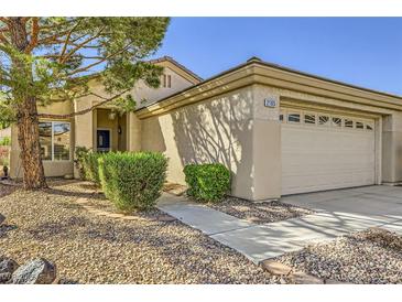 Charming single-story home with a well-manicured front yard and attached two-car garage at 2105 Poppywood Ave, Henderson, NV 89012