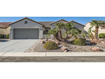 Charming single-story home featuring a low-maintenance rock garden and desert landscaping in the front yard at 2372 Perrysburg Dr, Henderson, NV 89044