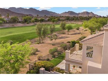 A balcony overlooks the backyard with golf course views and desert landscape, creating a serene outdoor space at 2933 Red Springs Dr, Las Vegas, NV 89135