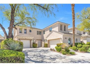 Stunning stucco home featuring a well-manicured lawn, two-car garage, and beautiful desert landscaping at 2933 Red Springs Dr, Las Vegas, NV 89135