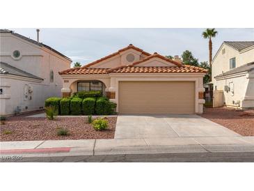 Charming single-story home with a well-manicured front yard and a two-car garage at 368 Legacy Dr, Henderson, NV 89014