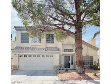Charming two-story home featuring an attached two-car garage and a well-manicured front yard with mature landscaping at 3695 Funston Way, Las Vegas, NV 89129