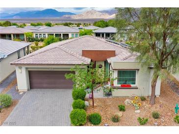 Charming single-story home featuring a desert landscape, two-car garage, and mountain views at 4914 E Beacon Ridge Dr, Pahrump, NV 89061