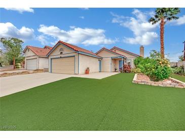 Charming single-story home with manicured lawn and desert landscaping and attached two-car garage at 5512 Kettering Pl, Las Vegas, NV 89107