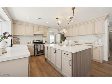 Beautiful kitchen with stainless steel appliances, a center island, and sleek countertops at 7825 Desert Bell Ave, Las Vegas, NV 89128