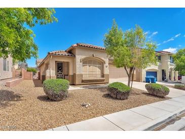 Charming single-story home with well-maintained front yard and desert landscaping on a bright day at 9588 Comiskey Ct, Las Vegas, NV 89148