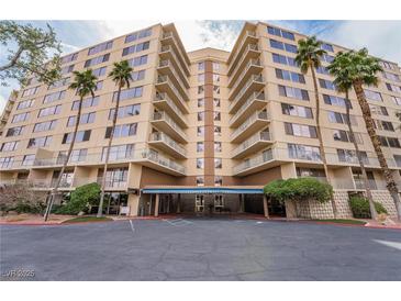 A luxury condo building featuring multi-story living with large balconies and mature tropical landscaping in a secure and welcoming setting at 205 E Harmon Ave # 409, Las Vegas, NV 89169