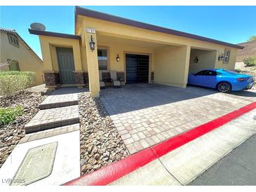 Inviting single-story home featuring a covered parking area and landscaped entrance at 2707 Chinaberry Hill St, Laughlin, NV 89029
