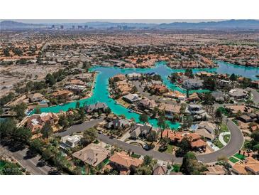 Gorgeous aerial view of lakeside homes in a beautiful planned community with lush landscaping and lake access at 2805 High Sail Ct, Las Vegas, NV 89117