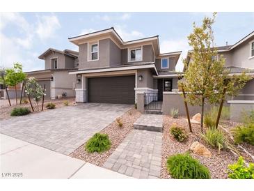 Beautiful two-story home featuring a paved driveway, a two car garage, and professionally landscaped yard at 356 Silva Pl, Henderson, NV 89011