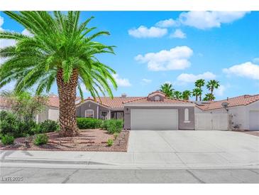 Charming single story home with desert landscaping, palm trees, and a two car garage at 4244 Totano Dr, North Las Vegas, NV 89032