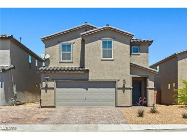 Charming two-story home featuring desert landscaping, neutral color palette, and attached two car garage at 438 Shimmering Sands Ave, North Las Vegas, NV 89031