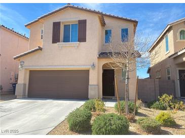 Two-story home with a two-car garage and desert landscaping at 5513 Silent Springs Dr, Las Vegas, NV 89122