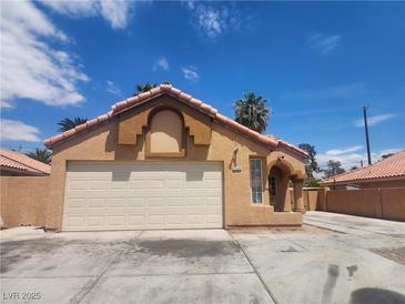 Charming single-story home featuring a two-car garage, terracotta tile roof, and stucco facade at 5536 Cleary Ct, Las Vegas, NV 89108