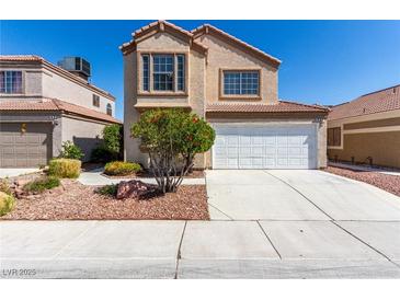Two-story home with desert landscaping, a two-car garage, and a neutral color scheme at 6428 Yarmouth Dr, Las Vegas, NV 89108