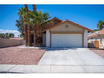 Charming single-story home with a two-car garage and desert landscaping at 684 Whispering Palms Dr, Las Vegas, NV 89123