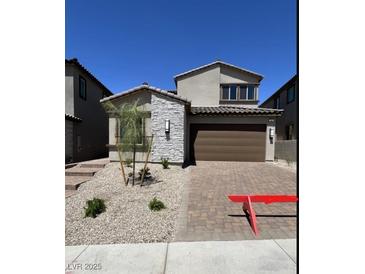Charming two-story home featuring a two-car garage, stone accents, and low-maintenance landscaping at 84 Via Franello, Henderson, NV 89011