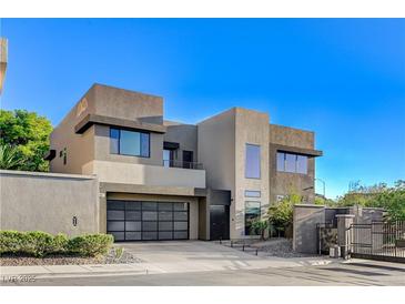 Contemporary two-story home featuring a stylish garage door and modern architectural design at 1181 Calle De Luz, Henderson, NV 89012