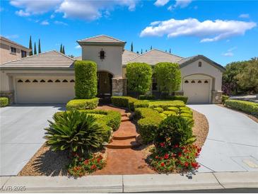 Charming single-story home with manicured landscaping, a three-car garage, and a welcoming entrance at 308 Kingsclear Ct, Las Vegas, NV 89145