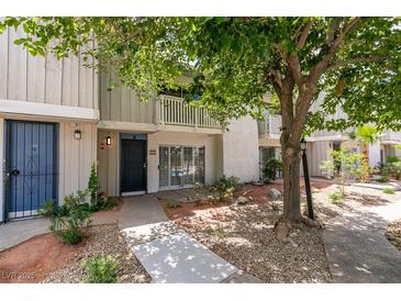 Charming two-story townhome featuring a private entrance and landscaped front yard at 516 Delfern Ln, Las Vegas, NV 89169