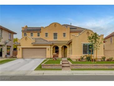 Charming two-story home featuring a tile roof, well-manicured landscaping, and a two car garage at 5642 Breckenridge St, North Las Vegas, NV 89081