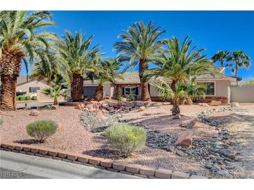 Beautiful single-story home with lush desert landscaping and towering palm trees at 6117 Foxcroft Ave, Las Vegas, NV 89108