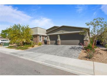 Charming single-story home with a spacious two-car garage and a beautifully landscaped front yard in a residential neighborhood at 6270 Lamont Hills Ave, Las Vegas, NV 89139