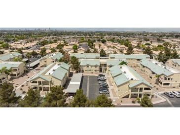 Wide aerial view of well-maintained community with mature landscaping and ample parking at 1509 Linnbaker Ln # 203, Las Vegas, NV 89110